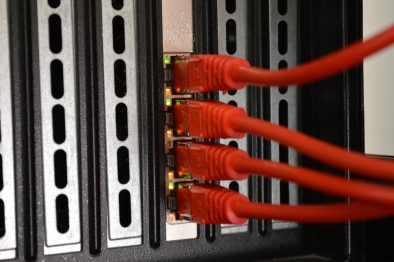 Back of a server with 4 red ethernet cable